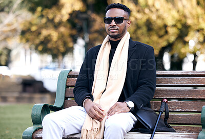 Buy stock photo Blind black man, park bench and relax with sunglasses, walking stick or outdoor by trees, peace or thinking. African guy, vintage fashion and young person with disability, glasses or travel in nature