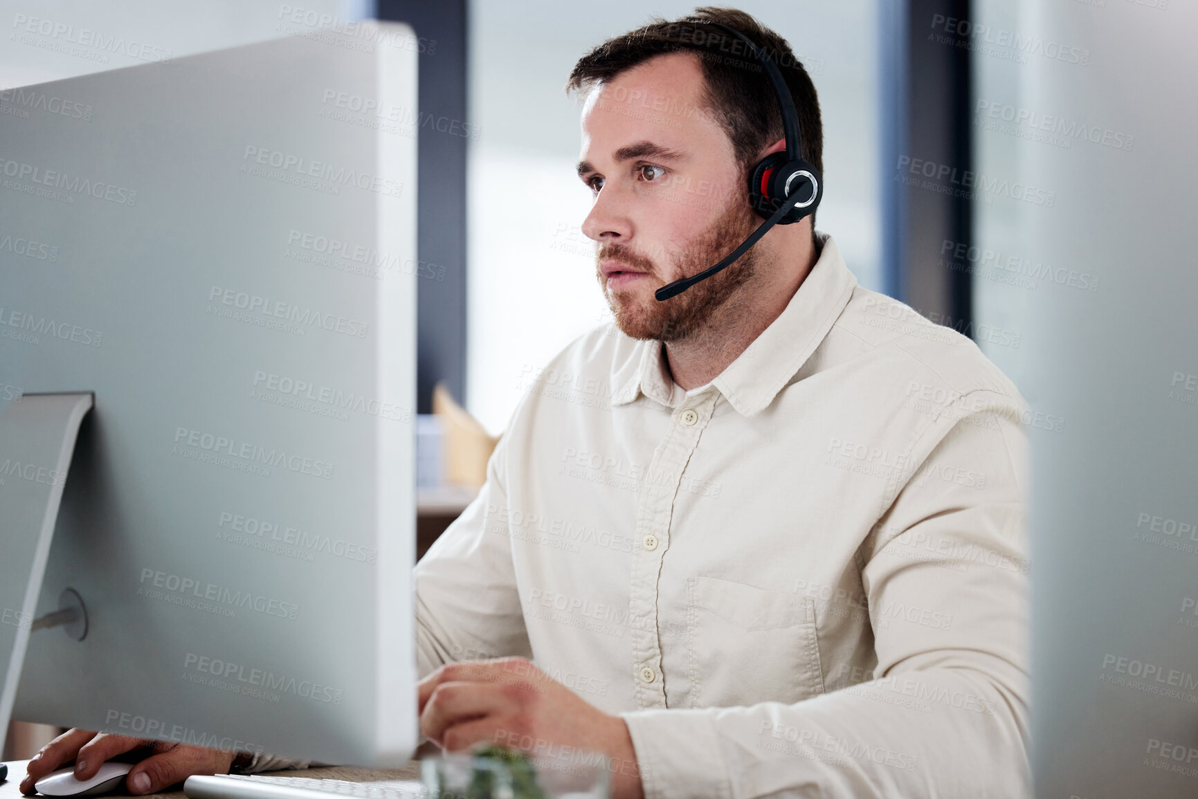 Buy stock photo Customer service, man with a headset and computer at desk of his modern office workplace. Telemarketing or online communication, support or crm and male call center agent at his workstation.
