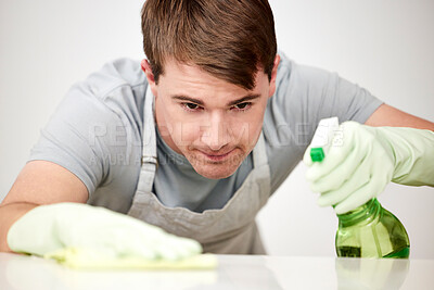 Buy stock photo Man, spray and cloth for cleaning table in home for bacteria, hygiene and safety from virus with domestic services. Person, cleaner and chemical in bottle with disinfection liquid for shine in house