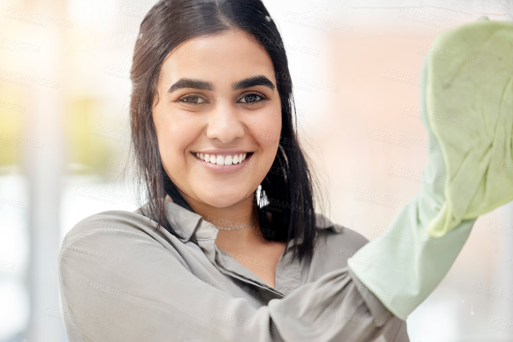 Buy stock photo Indian housewife, portrait and scrub cloth in house for cleaning, dust and dirt by glass. Woman, happy and smile with detergent or disinfectant for housework, housekeeping and spring cleansing