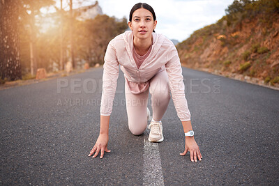 Buy stock photo Shot of a young woman in starting position while exercising outdoors