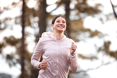 Buy stock photo Shot of a young female athlete running in nature