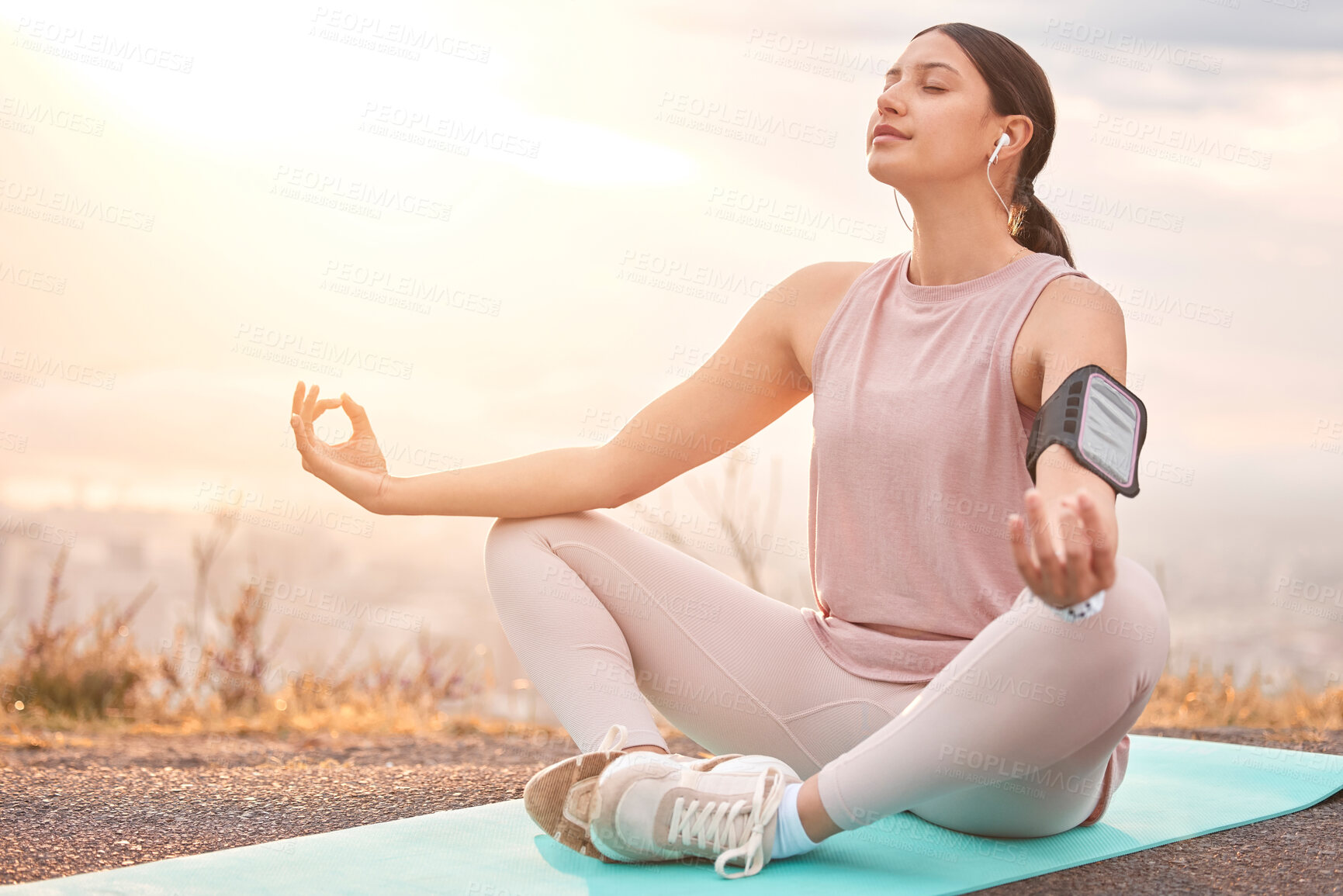 Buy stock photo Shot of a young woman meditating in nature