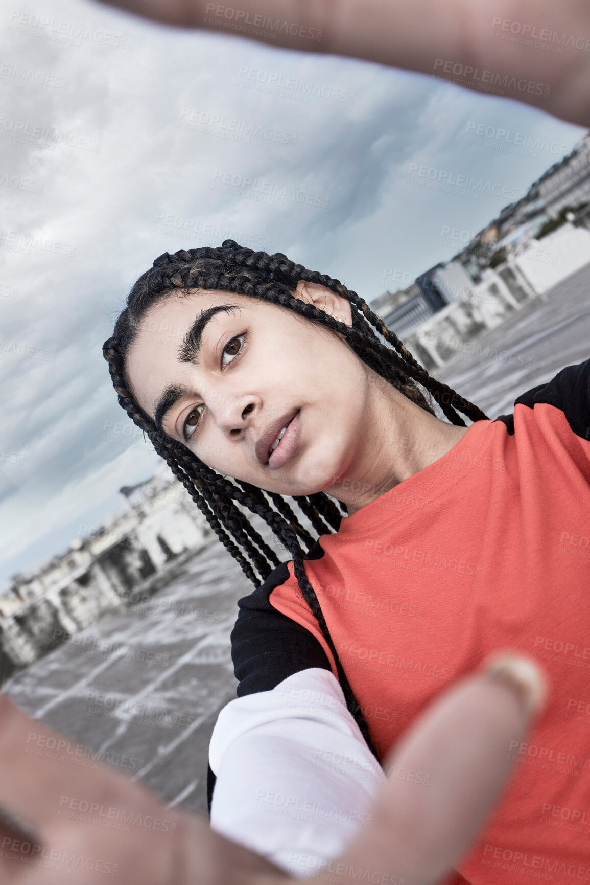 Buy stock photo Cropped portrait of an attractive young female dancer taking a selfie while standing on a rooftop against a stormy backdrop