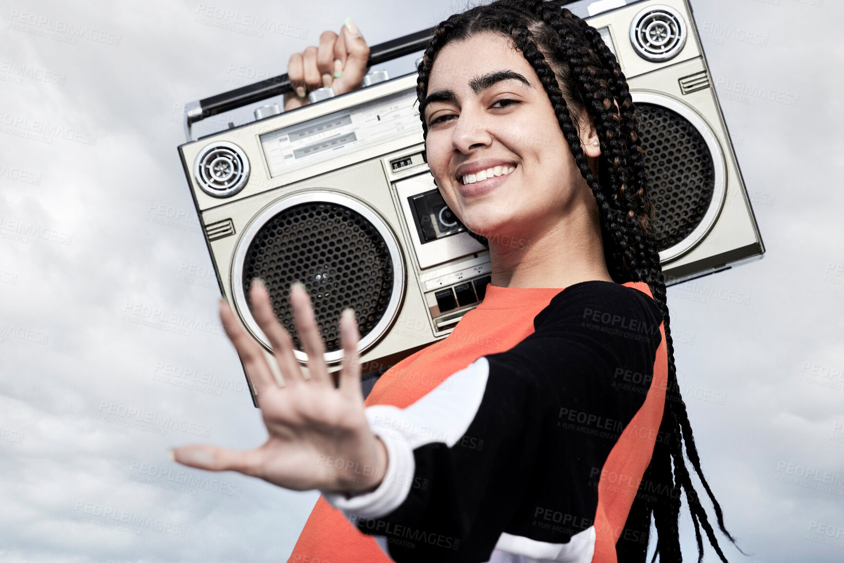 Buy stock photo Cropped portrait of an attractive young female dancer standing with her boombox against a stormy backdrop