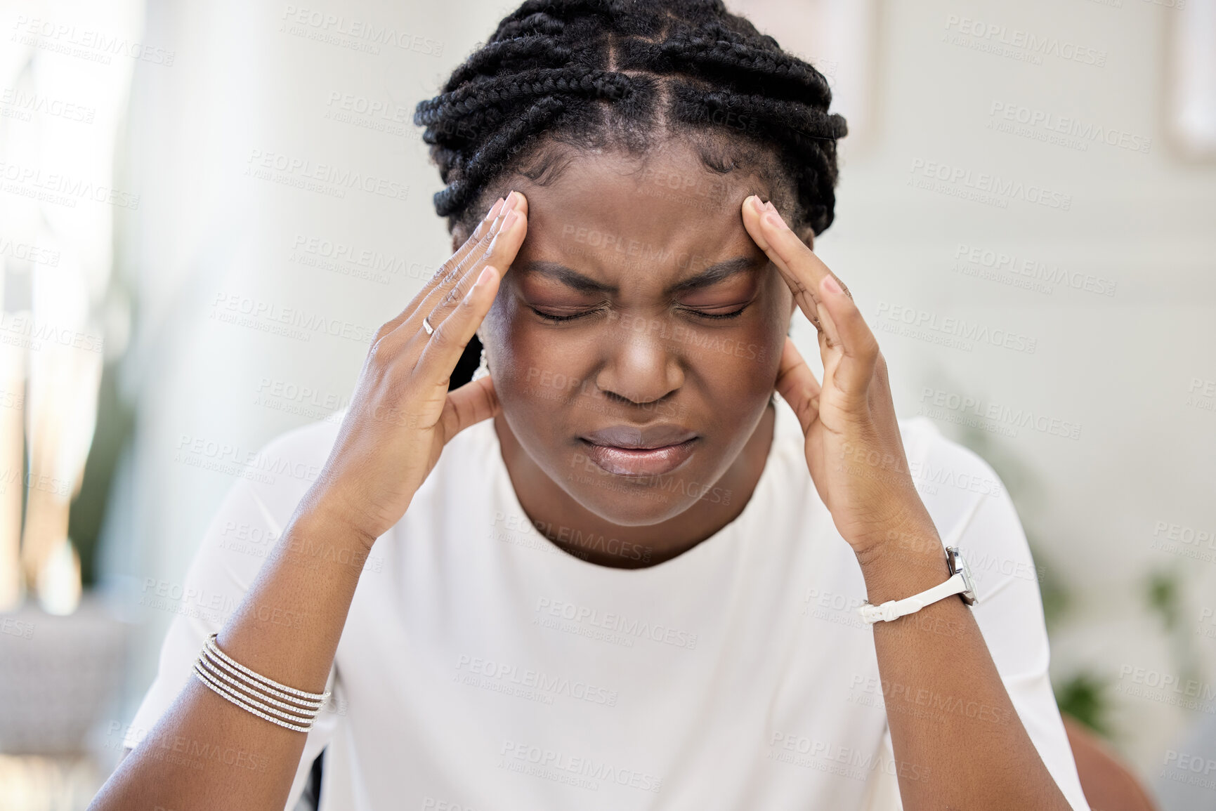 Buy stock photo Shot of a young businesswoman suffering from a headache at work