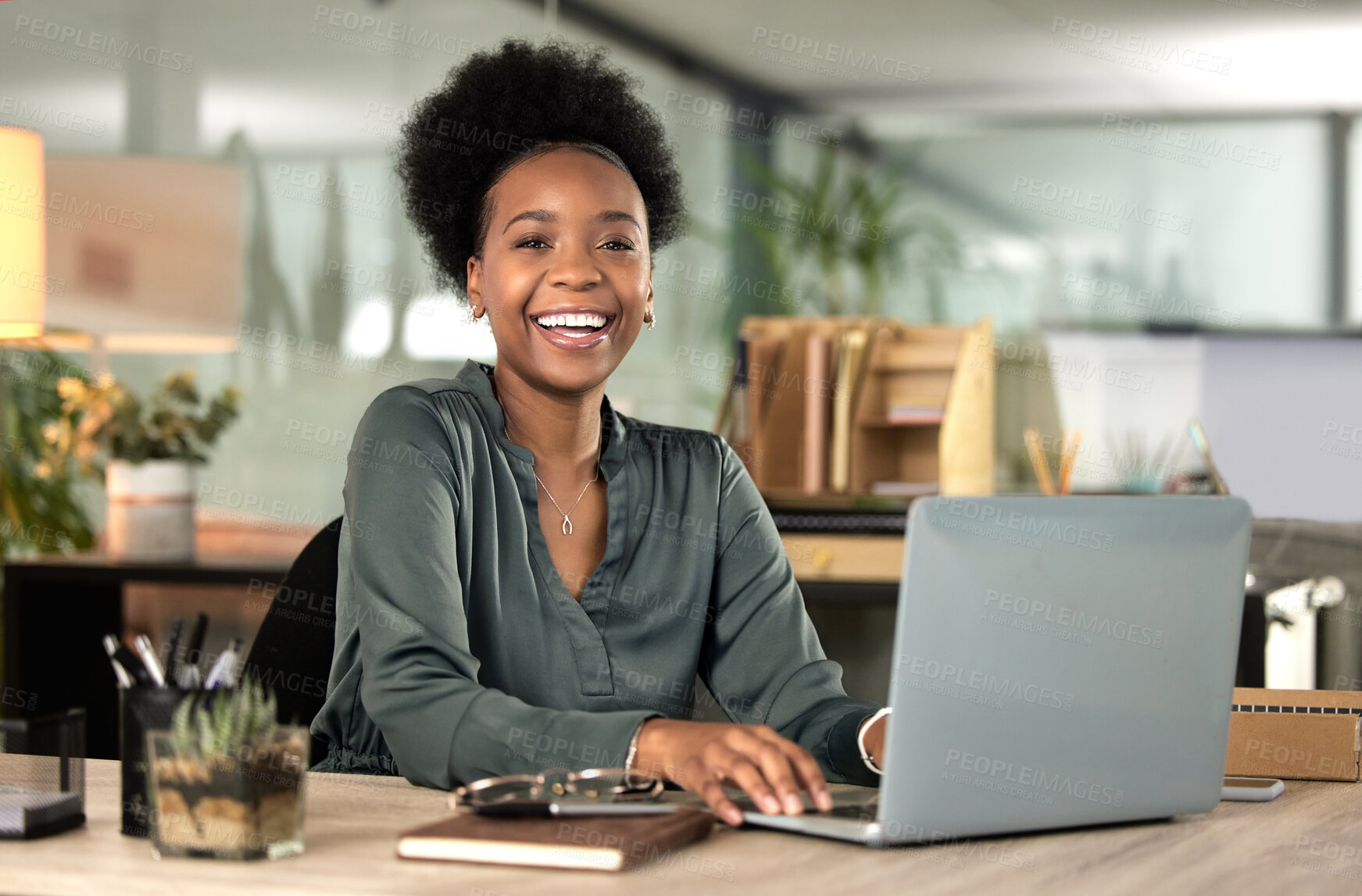 Buy stock photo Cropped portrait of an attractive young businesswoman working on her laptop in the office