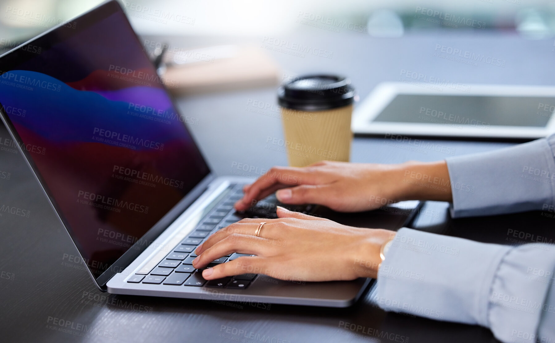 Buy stock photo Cropped shot of an unrecognizable businesswoman working on her laptop in the office