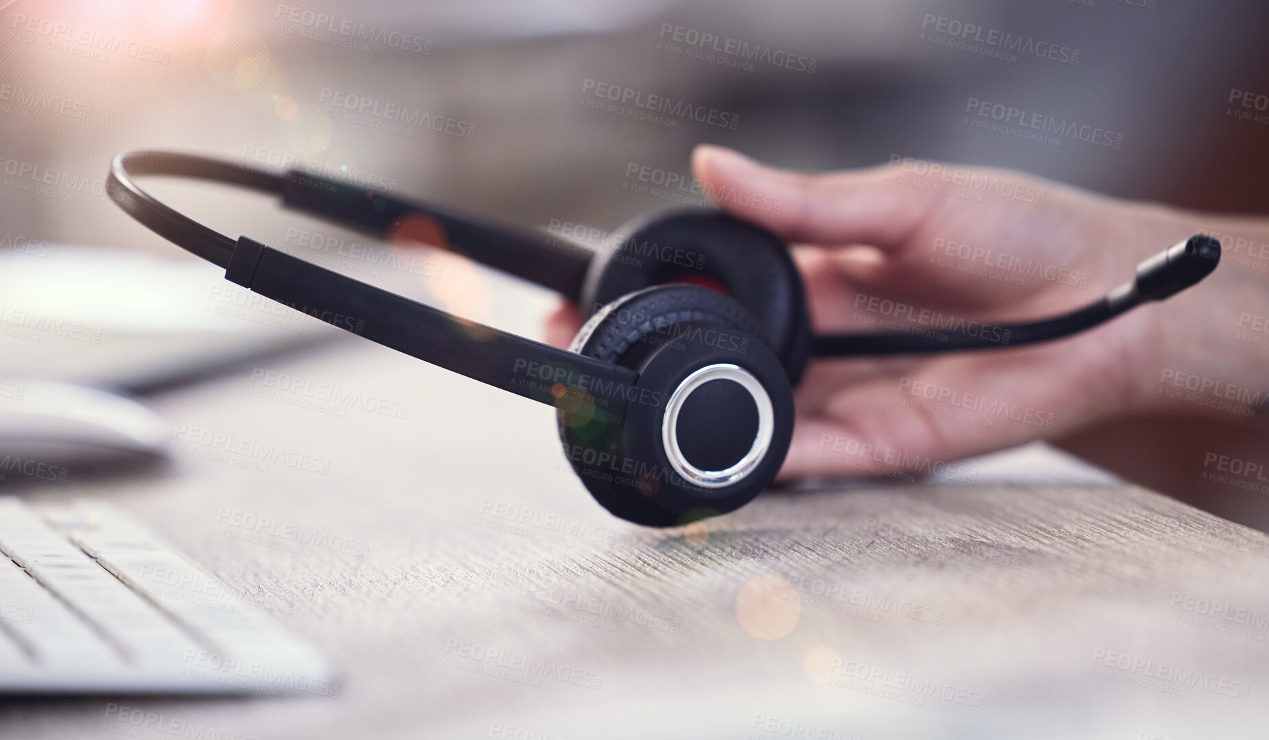 Buy stock photo Call center, desk and hand on person with headphones for telemarketing, sales call and consulting. CRM business, office and consultant with headset on table for customer service, ecommerce and help