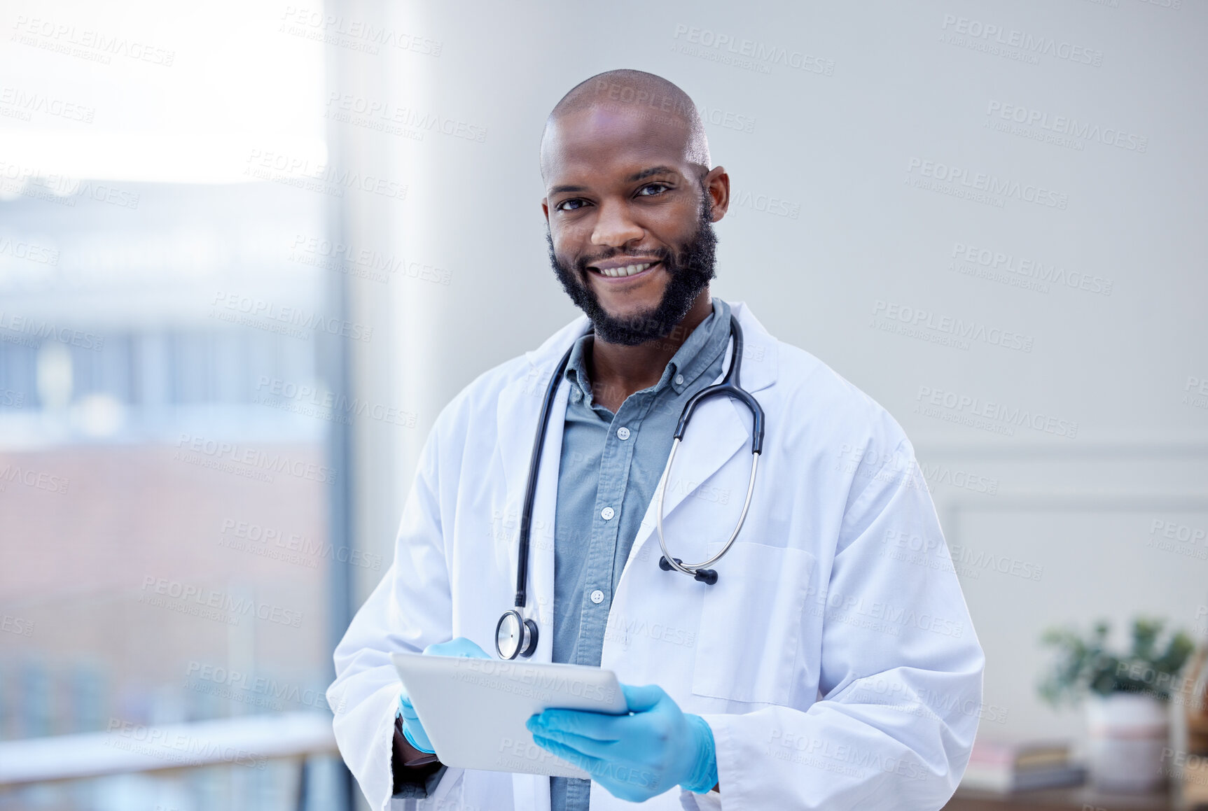 Buy stock photo Shot of a male doctor using a digital tablet