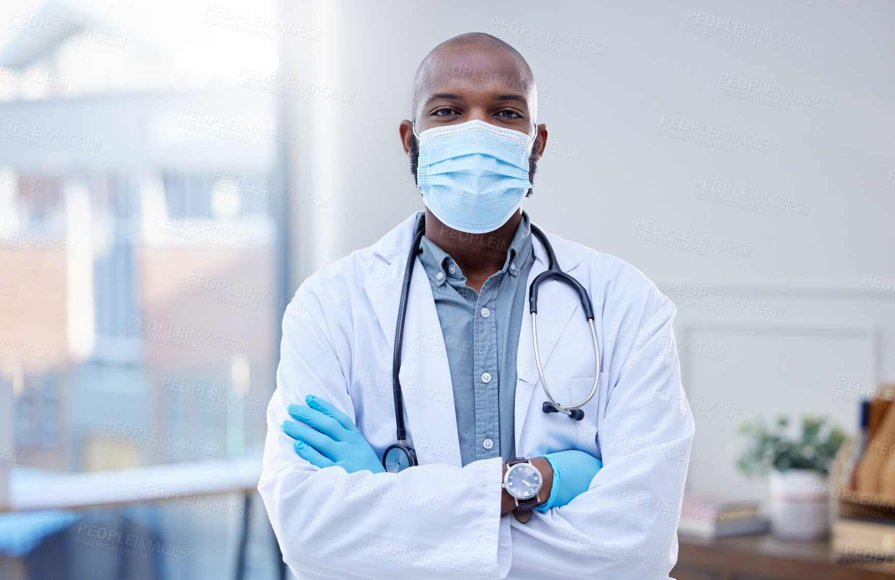 Buy stock photo Shot of a male doctor wearing a surgical mask and gloves