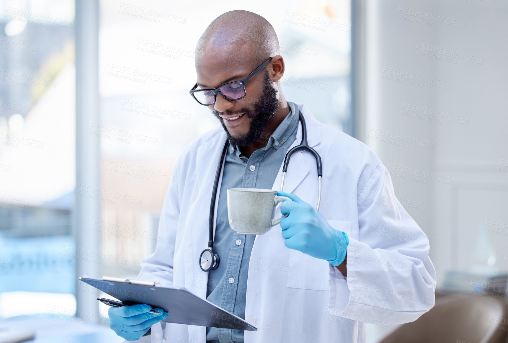 Buy stock photo Black man, doctor and clipboard for healthcare in hospital, medical paper and patient results. Male person, drinking coffee and reading record or chart in clinic, cardiologist and check insurance