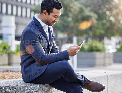 Buy stock photo Shot of a businessman using his smartphone to send a text