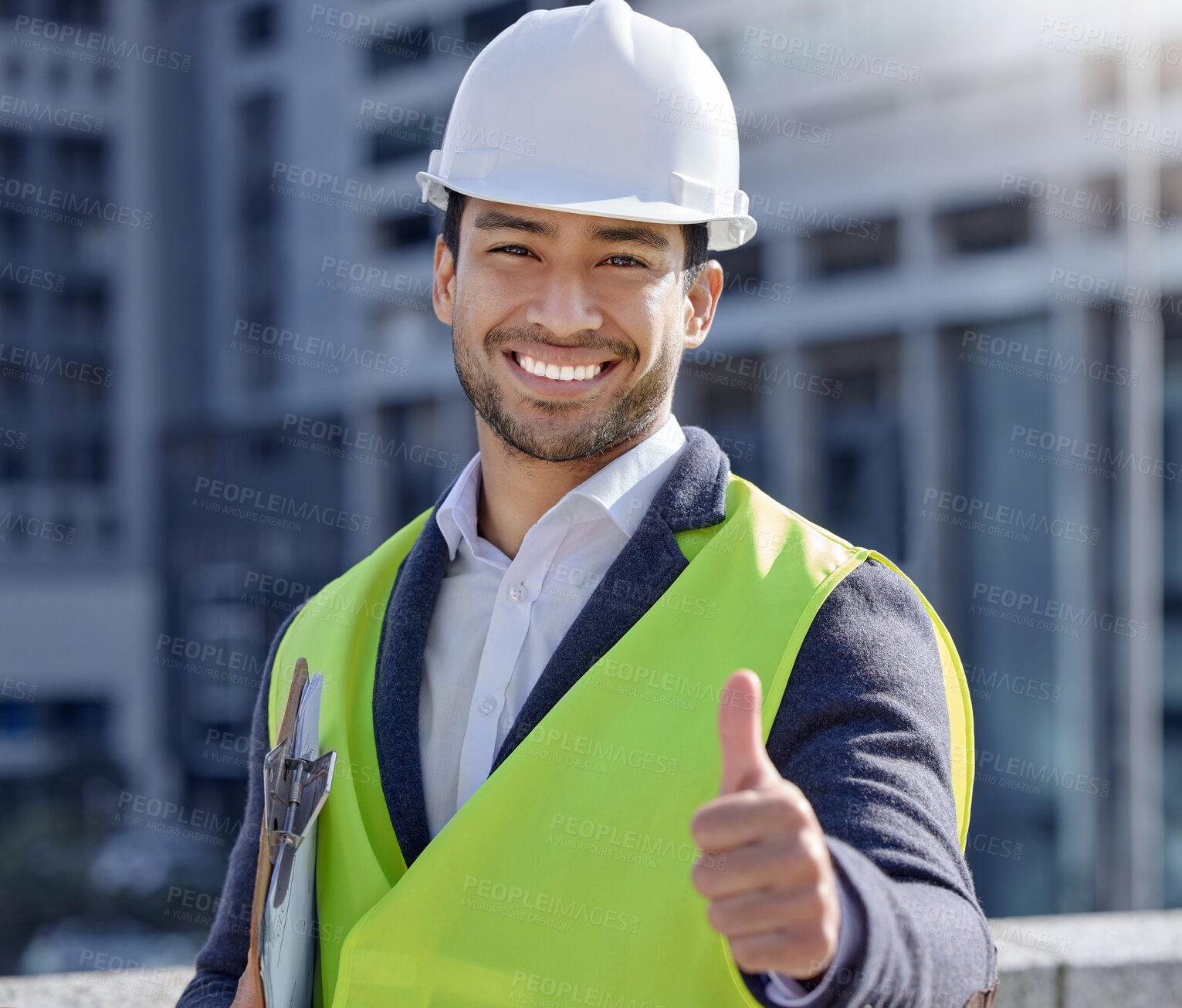 Buy stock photo Shot of a young businessman working on a construction site giving the thumbs up