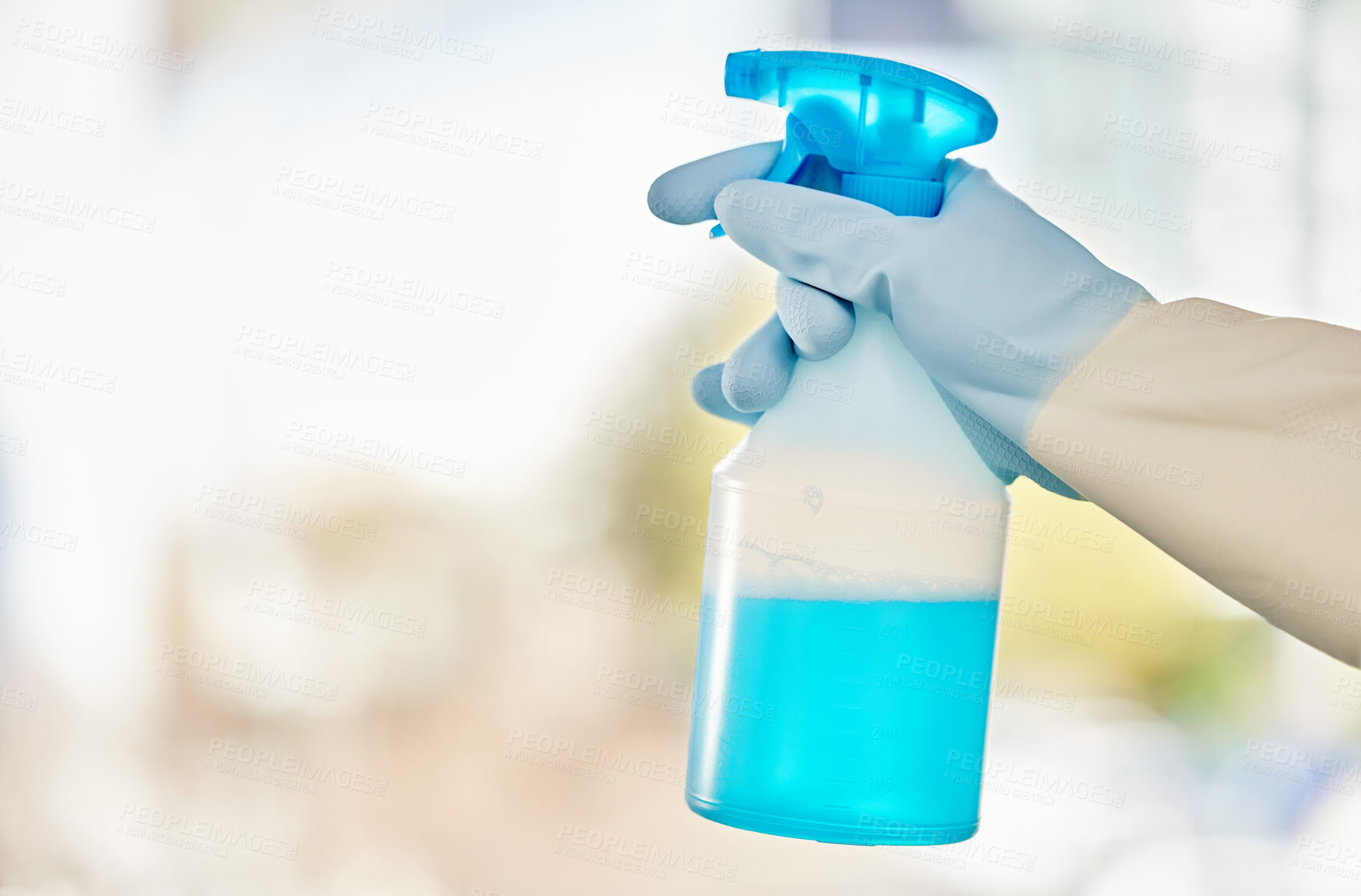 Buy stock photo Shot of a man holding a spray bottle of detergent