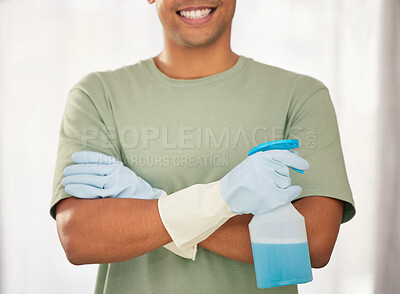 Buy stock photo Shot of a man holding a spray bottle of detergent