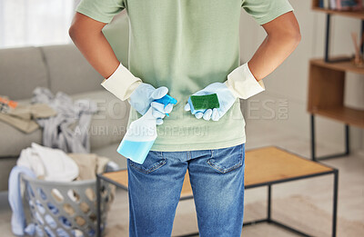 Buy stock photo Shot of a man holding a bottle of detergent and sponge ready to clean his home
