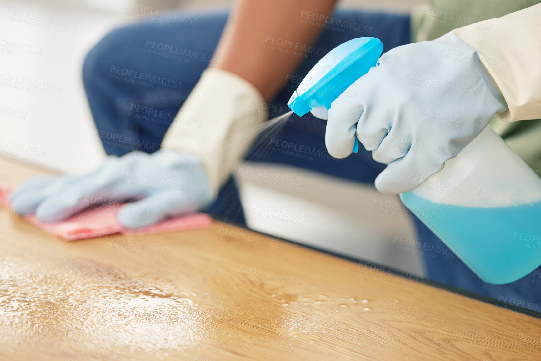 Buy stock photo Bottle, cleaning and hands in gloves at table in living room of home for domestic chores or housework. Bacteria, product and spray to wipe with person in apartment for disinfection or housekeeping