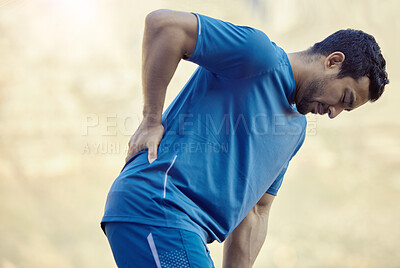 Buy stock photo Man, exercise and back pain or outdoor workout with pressure inflammation, injury or running. Male person, hand and strain accident on mountain path or sports athlete or hurt muscle, sprain or tender