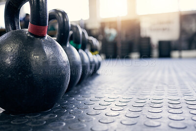 Buy stock photo Fitness, kettlebell and weights on floor of gym for training, wellness or workout with space. Background, metal equipment in health club and exercise for action, physical improvement or strength