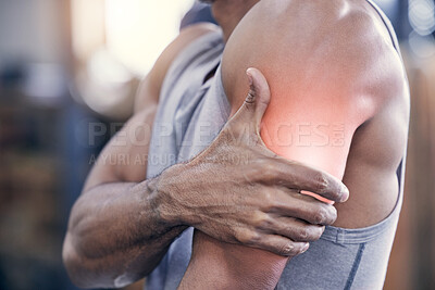Buy stock photo Closeup shot of an unrecognisable man holding his arm in pain while exercising in a gym