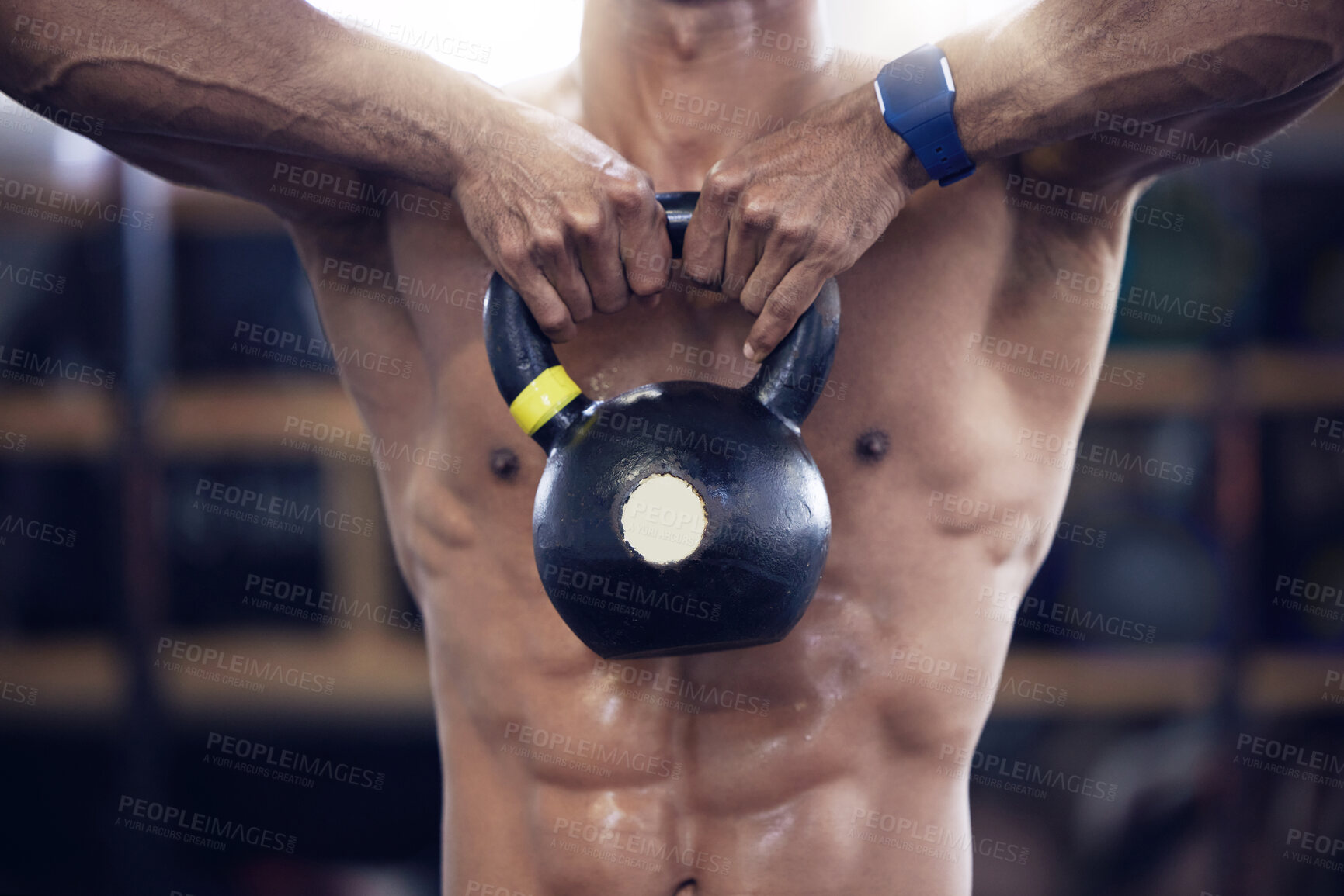 Buy stock photo Shot of an unrecognisable man working out with a kettle bell at the gym