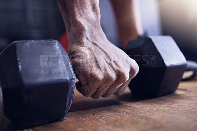Buy stock photo Shot of an unrecognisable man working out with a dumbbell at the gym