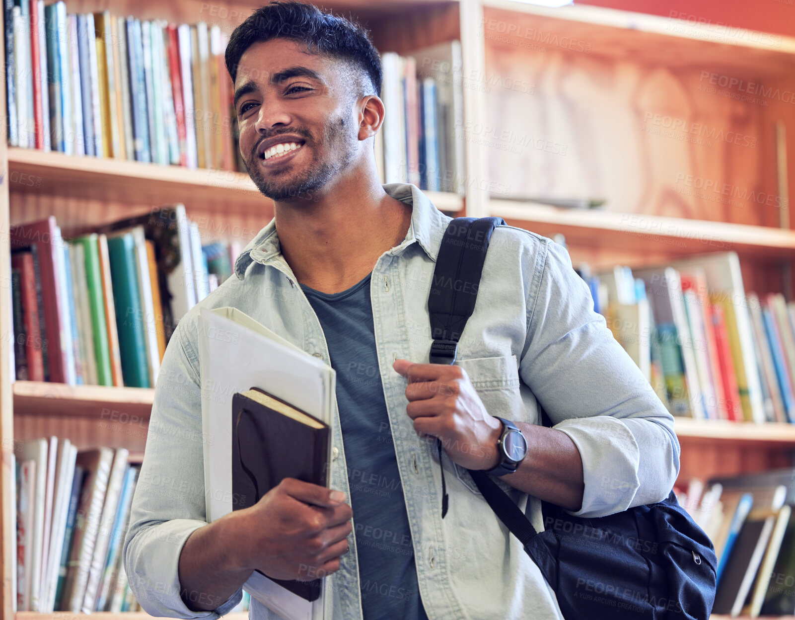 Buy stock photo Shot of a young man studying in a library at university