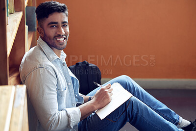 Buy stock photo Male student, portrait and smile in library for study in university with notebook for education with writing. Scholarship, academic and research for knowledge on campus for doctorate in London.