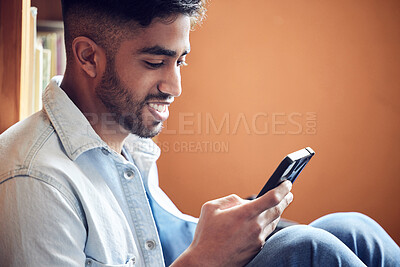 Buy stock photo Male student, smartphone and smile in library for study in university with notebook for education with person. Social media, academic or research for knowledge on campus for communication in London.