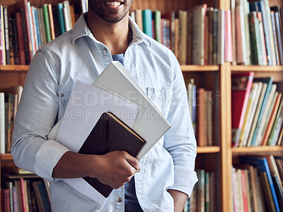 Buy stock photo Shot of an unrecognisable man studying in a library at university