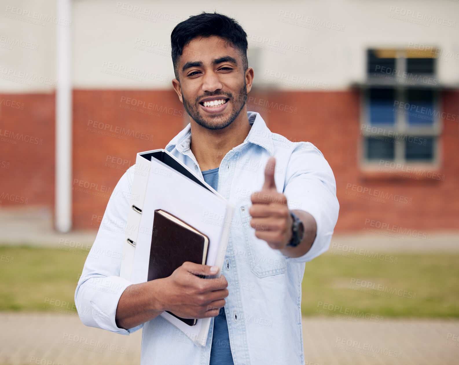 Buy stock photo Happy man, portrait and student with books and thumbs up for winning, vote or review at university campus. Young male person or learner with smile, like emoji or yes sign for good job or feedback