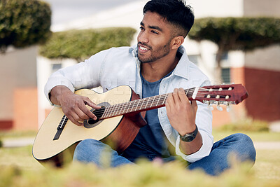 Buy stock photo Music, thinking and man playing guitar outdoor in garden to compose, practice or relax in summer. Art, inspiration or smile and happy guitarist or musician with instrument in park for talent