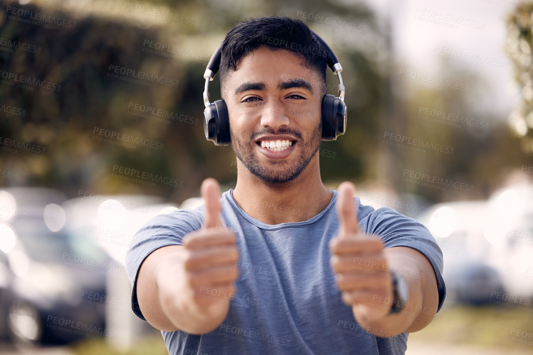 Buy stock photo Man, portrait and thumbs up with headphones for exercise playlist or radio streaming, approval or podcast. Male person, face and hand gesture for agreement review or music support, winning or yes