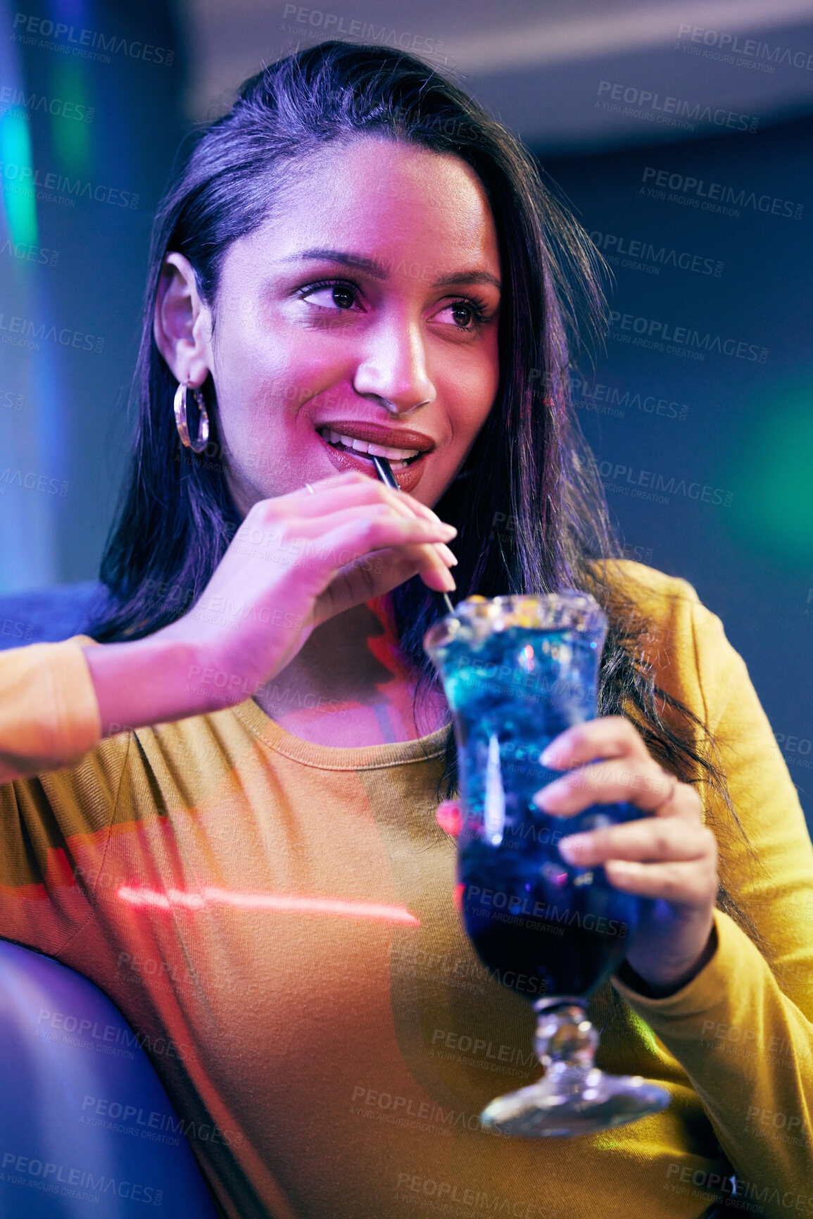 Buy stock photo Shot of a young woman having cocktails on a fun night out