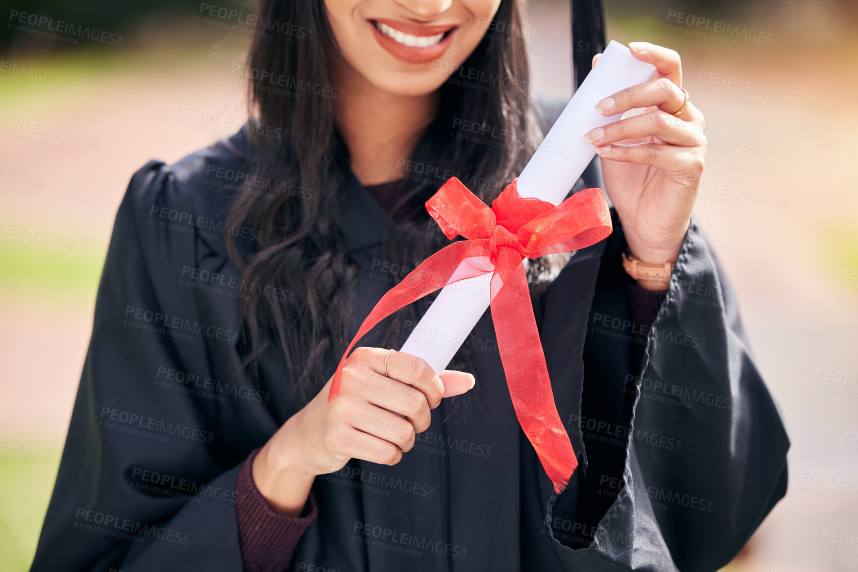 Buy stock photo Cropped shot of an unrecognizable young female student celebrating on graduation day