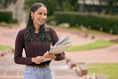 Buy stock photo Shot of a young woman carrying her schoolbooks outside at college