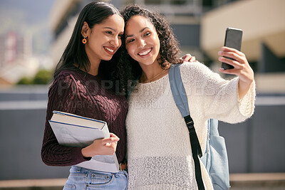Buy stock photo Shot of two young women taking selfies together at college