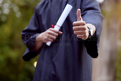 Buy stock photo Cropped shot of a young man showing thumbs up on his graduation day