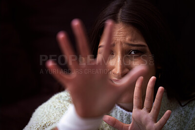 Buy stock photo Shot of a young woman looking distressed and reading out her hand