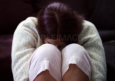 Buy stock photo Shot of a young woman sitting on the floor and looking distressed