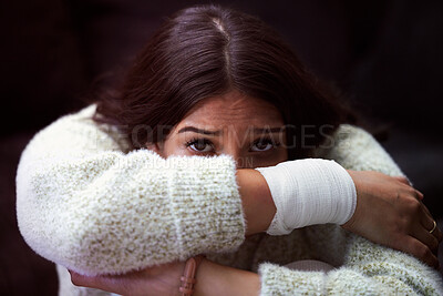 Buy stock photo Shot of a young woman sitting on the floor and looking distressed