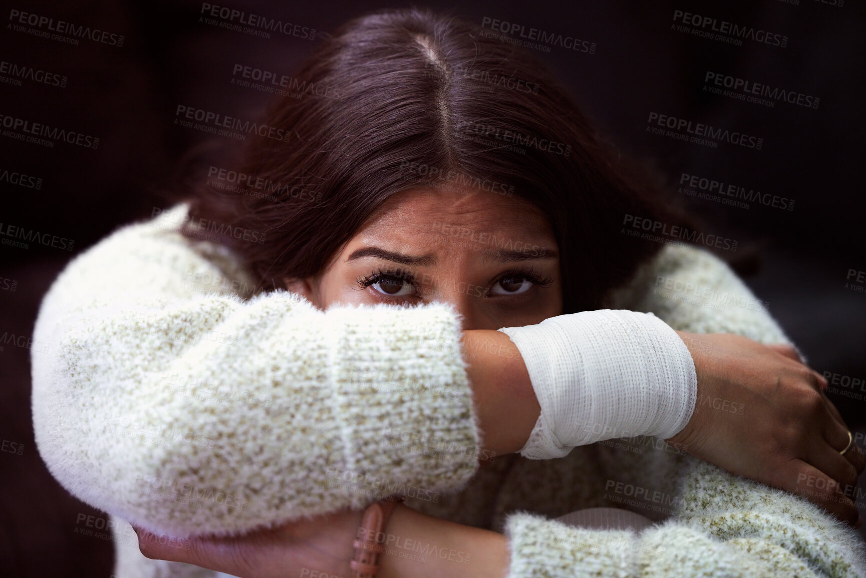 Buy stock photo Shot of a young woman sitting on the floor and looking distressed