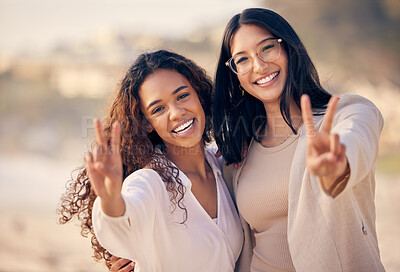 Buy stock photo Shot of a woman showing the peace sign while outside with her friend