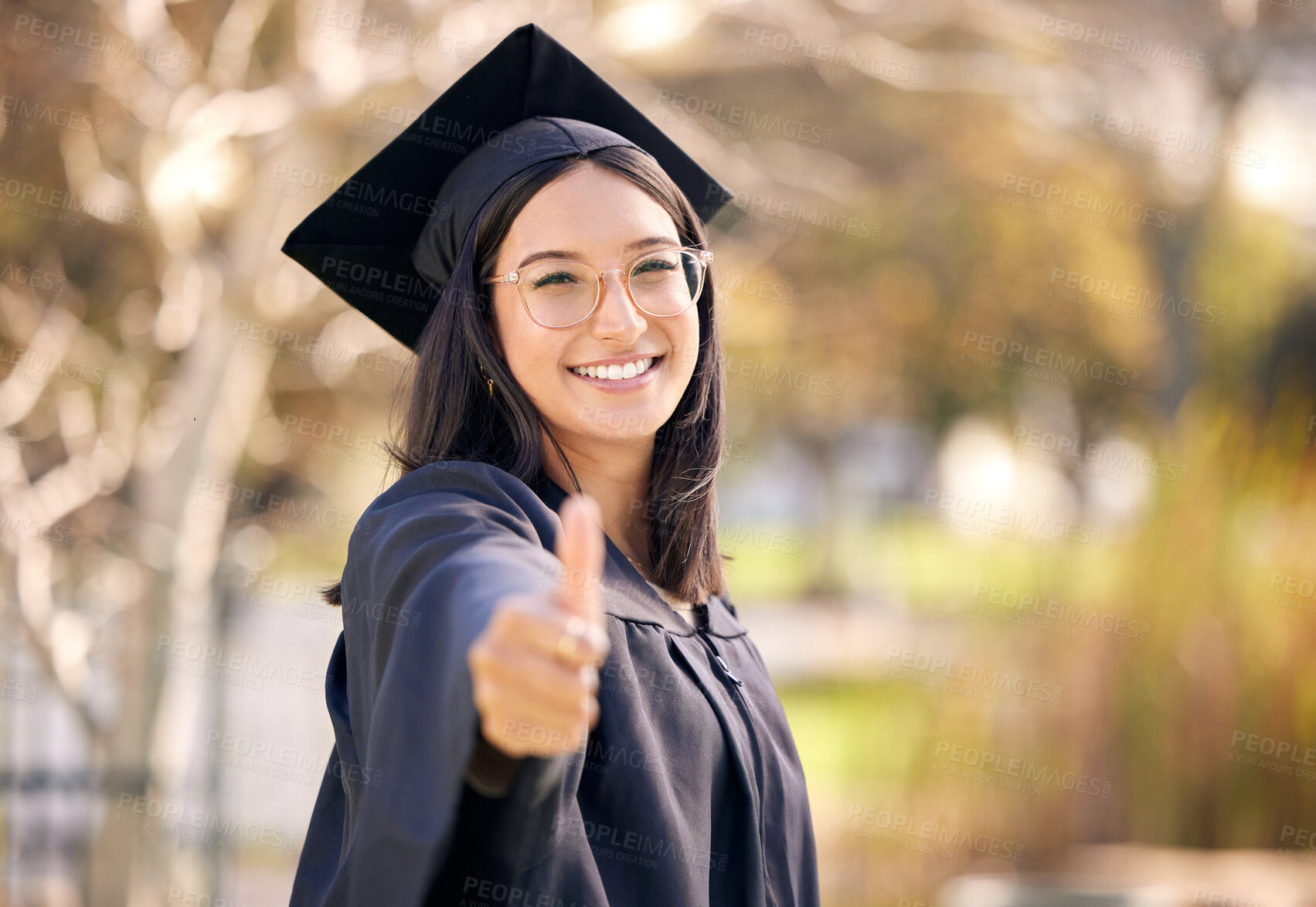 Buy stock photo Thumbs up, outdoor portrait and woman for graduation with celebration, scholarship and support for college. Female graduate, goal and hand with yes emoji in campus for promote education and success