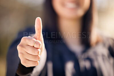 Buy stock photo Shot of an unrecognisable woman showing thumbs up on graduation day