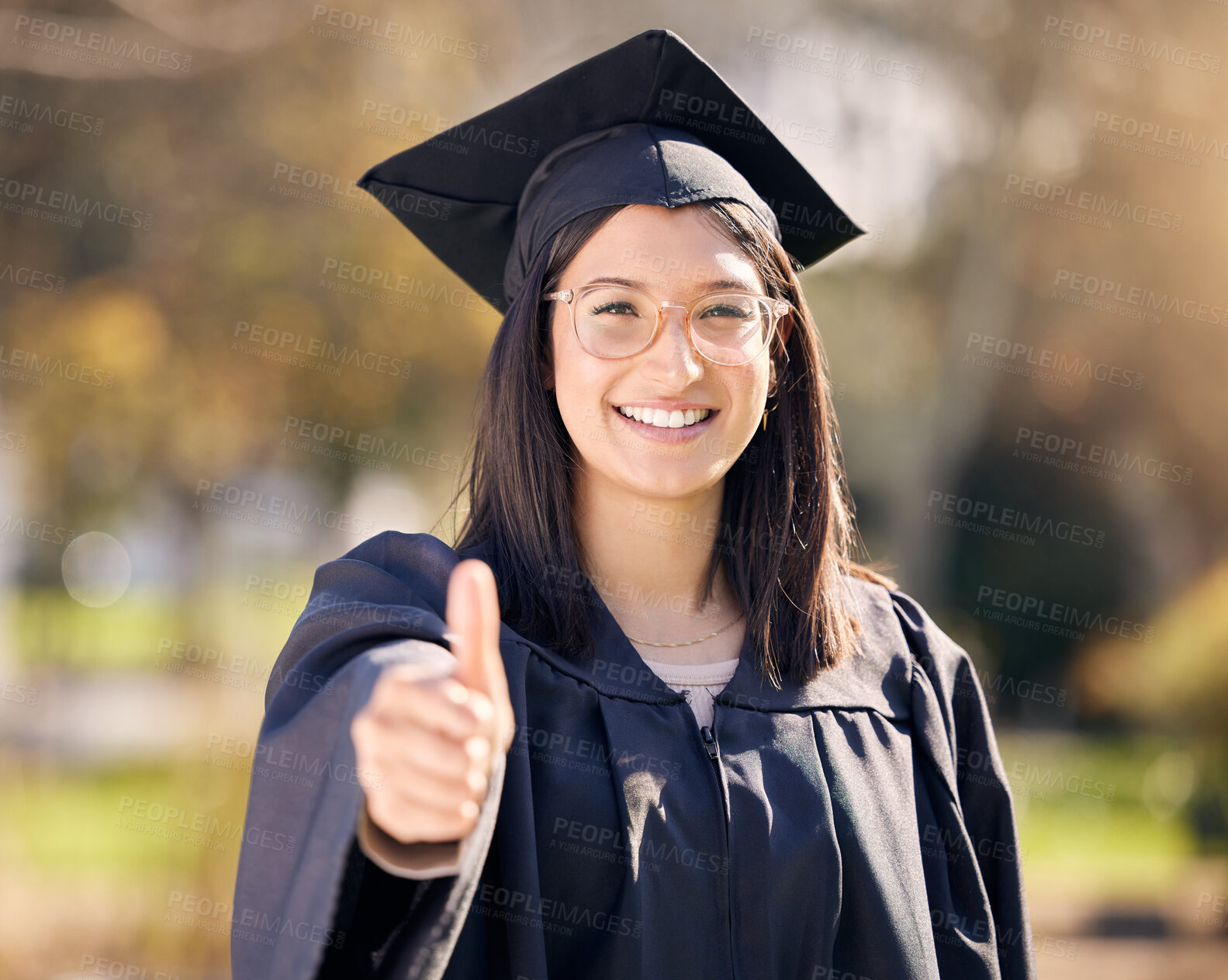 Buy stock photo Thumbs up, portrait and woman for graduation in college with celebration, scholarship and support for school. Female graduate, goal and hand with yes emoji in campus for promote education and success