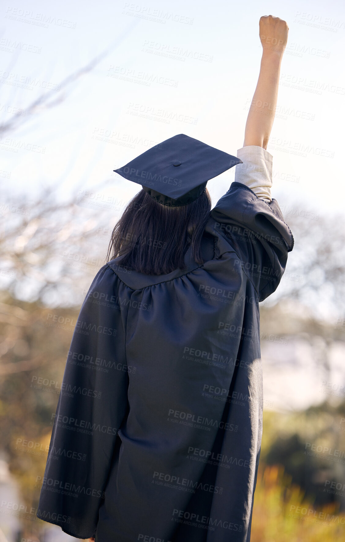 Buy stock photo Graduation, celebration and back of student with cheers at college or achievement in education. Study, success and person at university on scholarship with pride for winning diploma or fist in air
