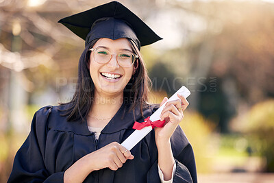 Buy stock photo Shot of a young woman holding a certificate on graduation day