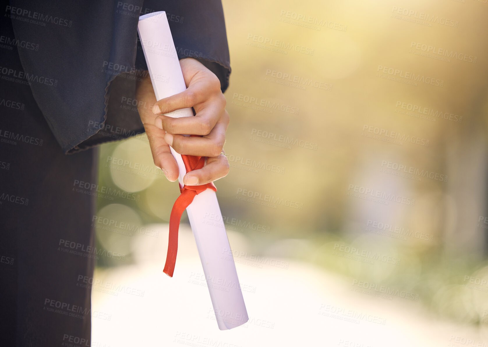 Buy stock photo Shot of an unrecognisable woman holding a certificate on graduation day